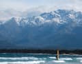 In der Bucht von Calvi surft man mit Blick auf die imposante Kulisse Korsikas. Die Berge rund um den über 2700 Meter hohen Monte Cinto sind im Frühjahr oft noch vom Schnee bedeckt.