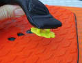 ...inserts the plastic plates into the loops...