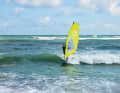 Position yourself at a safe distance on a wave that is building up and surf with it towards the beach