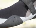 Narrow-cut shoe with drains on the side.