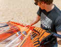 Push the mast into the mast pocket from below and pull in "concertina style" until the sail is fully hoisted.
