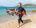 If your arms are long enough, simply clamp the board under your arm with the deck facing your body