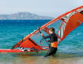 If you tilt the boom end towards the water (luffing), the board will turn into the wind (upwind).