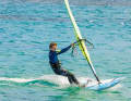 To carve to windward, move the back foot slightly towards the windward edge