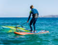 Bend your knees slightly, keep your back straight and pull the sail just a little way out of the water. The wind will now turn the sail like a flag with the wind to the leeward side...