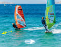 Ideally, the overtaking surfer (left) passes on the windward side to have free wind