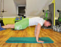 Get into a push-up position and hang your legs on the trapeze