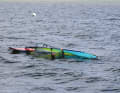 Grip the mast slightly above the boom and lift it slightly so that some wind gets under the sail