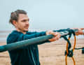 Every surfer's forearms start to ache when the temperatures are freezing and they have to wear gloves. Cramps are also not uncommon after a long winter break. Grip the boom so that both palms are facing upwards and stretch it away from you.