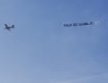 His sponsor is celebrating him with a plane circling above the beach.
