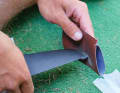 A bit of sandpaper to sand down any minor damage to the fin