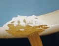 The laminate surrounding the sides is sanded at a very shallow angle and then everything is thinly dabbed with resin