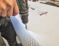 Sven drills three small holes in the crack.