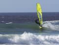 Gain as much speed as possible on the building wave and aim for the wave on the windward side.