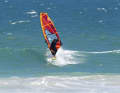 You are now surfing standing back with your back to the sail. As with every backstroke, don't push too hard into the clew, as this is like a tight haul, which causes the sail to load up and throw you off the board to leeward like a wild horse.