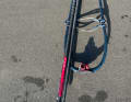 Lay the boom flat on the ground and position the mast on it first. The buckles on the harness ropes generally prevent the mast from rolling sideways, otherwise fold it up.