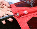 ...depending on the system, push the thread out of the groove using pliers or tweezers. Take care not to damage the thread when doing so