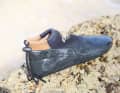 The upper stops just below the ankles, and the sole material is pulled up well around the heel and toes.
