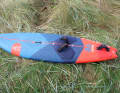 The board has a round outline with narrow nose and tail sections