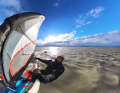 Father Christmas surfing two days before Christmas in Podersdorf on Lake Neusiedl (Austria)