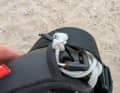 Wrap the spare rope around the hook or the harness straps, for example