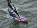 While the board continues to drop downwind, you now climb out of the front loop almost like a split and position your front foot in front of the base plate (as in a fast tack).