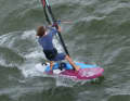 Once the sail has reached the downwind course, the back hand opens the sail to release pressure before letting go of the boom completely. This is followed by a cross grip on the other side of the boom, the grip technique is similar to a (boom-to-boom) tack.