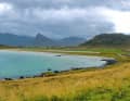 Between the rugged mountain massifs, you will repeatedly come across shallow sandy bays, such as here north of Fredvang.