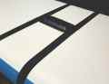 An additional fin box is attached under the centre of the board using two tensioning straps