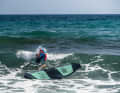 Even when crossing waves, the body always remains on the top of the board, with a firm grip on the straps