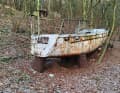 Time travel of a boat that has been lying in the forest for around 50 years. The picture from today illustrates the absurd position of the boat