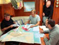The crew conducting research. Various sources are consulted and the information is then analysed