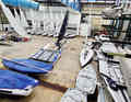 The sailors' dinghies are piled up in the boat hall
