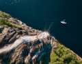 The author and his boat have the mooring in front of the waterfall that plunges into the fjord all to themselves