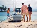 A trip under palm trees. The dinghy takes the three young men and their friends ashore on Coco Banderos in the San Blas Islands