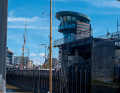 A yacht leaves the Neuer Hafen lock seaward. The lock keeper has everything in view at the top of the tower