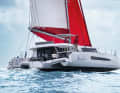 The helm station is raised on one side. Steps lead up to the flybridge lounge on the upper deck