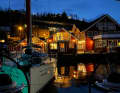 Evening atmosphere in the harbour of Lyngseidet, where the boats are moored in front of typical Scandinavian wooden houses.