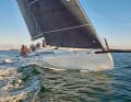Striking appearance: long carbon sprit with water stay, retracted freeboard, kinked and sharpening stem at the bottom.