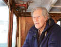 Hans-Christer Edborg at the helm of his "Svanevik". He has spent more than half a century on the historic Galiot.