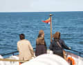 During the journey, the mourners look out towards the place where the urn will soon be buried.