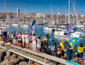 For the traditional departure parade, the piers of the marina are filled with friends and acquaintances waving goodbye to the crews.