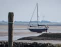 At low tide, a sailing boat ran aground in the mudflats between the island of Baltrum and the mainland.
