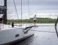Walk on the raised starboard foil - a member of the "Raven" crew checks the yacht's side arm and wing profile