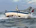After a sailing yacht ran aground on a sandbank off Norderney, its keel and mast broke. The badly damaged boat is defencelessly exposed to the forces of the sea