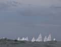 The world championship fleet of Ilca-6 sailors on the Argentinian horizon
