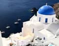 White buildings, blue roofs, picture-book Greece.