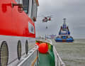 (2) Together with a rescue helicopter from NHC Northern Helicopter, the sea rescuers approach the tug "Fairplay 34" with the rescue cruiser EUGEN/Norderney station (l.) and the daughter boat EMMI of the rescue cruiser HANS HACKMACK after an assumed collision.