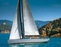 Mediterranean dreams. The Vismara V50 "Dragon" in front of the Scoglio dello Sparviero near Punta Ala: elegant ship on azure waters