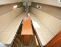 Saloon: Open-plan layout with sunbathing area in the bow and hull windows. The retractable keel sits in the saloon table